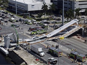 Emergency personnel respond after a brand-new pedestrian bridge collapsed onto a highway at Florida International University in Miami on Thursday, March 15, 2018. The pedestrian bridge collapsed onto the highway crushing multiple vehicles and killing several people.