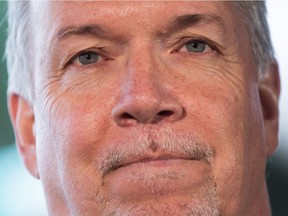 British Columbia Premier John Horgan pauses while speaking during an announcement about child care, at a daycare in Coquitlam, B.C., on Wednesday March 28, 2018.