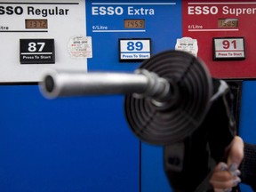 Gas prices are displayed as a motorist prepares to pump gas at a station in North Vancouver, B.C., Tuesday, May 10, 2011.