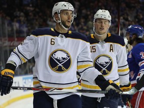 Marco Scandella and Jack Eichel of the Buffalo Sabres react after a goal by the New York Rangers on March 24, 2018.