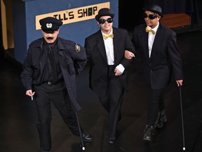 Shaun Bernd Romano, left, as policeman, Yuki Masuda as Loby and Norjine Gangan as Koby in St. Joseph High School's Cappies production of The Visit in Edmonton, March 7, 2018.