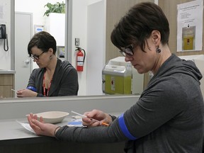 Katrina Stephenson, the staff nurse at the Boyle Street Community Services supervised consumption site, demonstrates the procedure that clinic users will go through when using the site, which opens Friday March 23, 2018. This is the first safe consumption site to open in Edmonton.