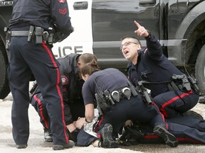 Calgary Police tend to one of their own who was shot at scene in Abbeydale on Tuesday March 27, 2018.