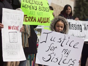 Protesters hold signs outside city hall in support of Cindy Gladue in Edmonton on April 2, 2015. The Supreme Court of Canada will hear an appeal in the case of an Ontario trucker acquitted of murdering an Indigenous woman in an Edmonton motel room. In March 2015, Bradley Barton was found not guilty by a jury in the death of Cindy Gladue, a sex-trade worker whose body was found in a bathtub.