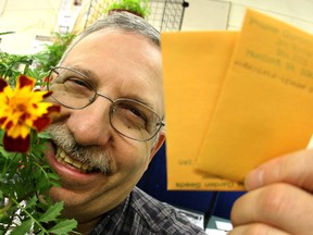 Neil Lang dispenses Marigold seeds in this file photo from Seedy Sunday, 2010, in Edmonton.