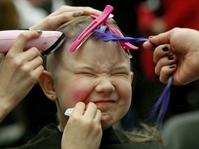 Emmalee Phair (10-years-old) gets her head shaved at Hair Massacure on Friday March 23, 2018. The annual event, held at West Edmonton Mall’s Ice Palace, attracted people of all ages, many with pink hair, who shaved the hair off their heads in a fundraiser to support the Children’s Wish Foundation of Canada and the Alberta Cancer Foundation. (PHOTO BY LARRY WONG/POSTMEDIA)