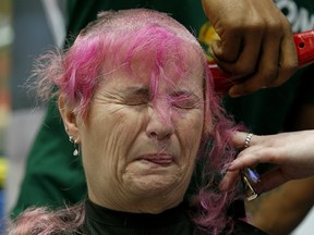 Denise Collins gets her head shaved at Hair Massacure on Friday March 23, 2018.