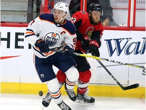 Edmonton Oilers centre Connor McDavid (97) collides with Ottawa Senators defenceman Fredrik Claesson (33) during second period NHL hockey in Ottawa on Thursday, March 22, 2018. Fred Chartrand