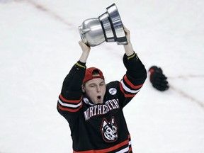 Northeastern forward Adam Gaudette hoists the Beanpot trophy after defeating Boston University in this file photo from the championship game of the Beanpot tournament in Boston on Feb. 12, 2018. (File)