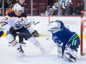 Edmonton Oilers left wing Milan Lucic (27) is stopped by Vancouver Canucks goaltender Jacob Markstrom in Vancouver on Thursday, March 29, 2018. (The Canadian Press)