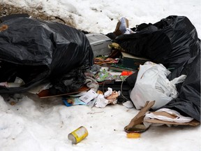 Garbage left behind after a homeless camp was cleared out in Dawson Park on Friday, March 2, 2018.