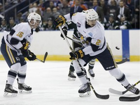 Spruce Grove Saints' Graeme Bryks (29) and Cam Mitchell (16) play the Okotoks Oilers in the final hockey game to be held at Northlands Coliseum in Edmonton, Alberta on Friday, December 15, 2017. Photo by Ian Kucerak