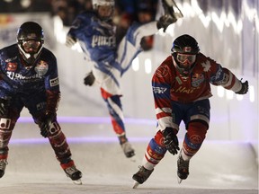 Alex Mercier, right, from Canada leads a race in the Last Chance Qualifiers race during Red Bull Crashed Ice competition in downtown Edmonton, Alta., on Friday, March 9, 2018.