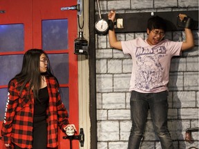 Rachel Pang, left, as Wednesday and Francis Nievera as Pugsly perform during a rehearsal of Blessed Oscar Romero High School's Cappies production of the Addams Family in Edmonton on Tuesday, March 13, 2018.