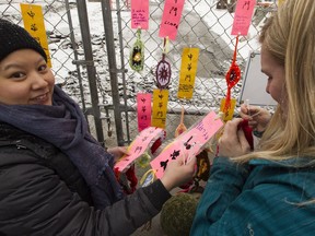 Members of Edmonton's Chinese community and supporters put up calligraphy art banners to remember the Harbin Gate, which was removed on November 4, 2017 for LRT construction, in Edmonton, Alberta on Saturday, March 17, 2018.