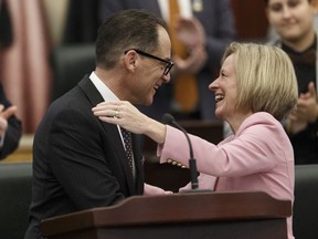 Alberta Finance Minister Joe Ceci (left) hugs Premier Rachel Notley after delivering Budget 2018 in the Alberta Legislature in Edmonton, on Thursday, March 22, 2018. Photo by Ian Kucerak/Postmedia