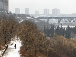 A woman listens to music while walking in Victoria Park after a snowstorm in Edmonton, on Friday, March 23, 2018.