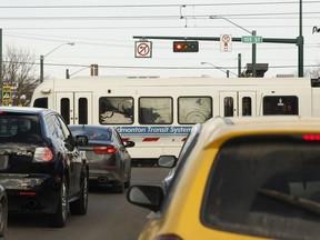 Traffic waits as a Metro Line LRT train crosses 107 Avenue at 105 Street in Edmonton on Wednesday, March 29, 2017.