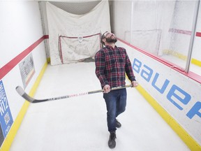 Reporter Juris Graney tries a hockey stick in the shooting lanes at United Cycle in Edmonton on February 8, 2018 for his series on learning to play hockey.