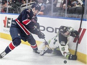 Kobe Mohr of the Edmonton Oil Kings slides into the boards in front of Libor Hajek of the Regina Pats at Rogers Place in Edmonton on March 4, 2018. (Shaughn Butts)