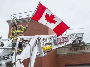 Wes Bauman descends the ladder from the roof on Hall 2. Firefighters who have been camping on the rooftop of Station 2 have come down after raising $100,000 for Muscular Dystrophy Canada on March 1, 2018.  Photo by Shaughn Butts / Postmedia