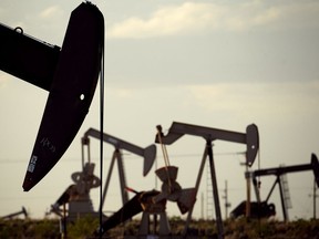 FILE - In this April 24, 2015 file photo, pumpjacks work in a field near Lovington, N.M. The boom in US oil production is expected to satisfy most of the world's growing appetite for oil through 2023, according to a new forecast by a global energy group. The International Energy Agency worries that that investment in oil exploration and production is too low. The result could be the thinnest margin of oil-production capacity over demand in more than a decade.