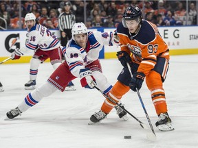 Ryan Nugent-Hopkins of the Edmonton Oilers, is shadowed by Rob O'Gara of the New York Rangers at Rogers Place in Edmonton on March 3, 2018.