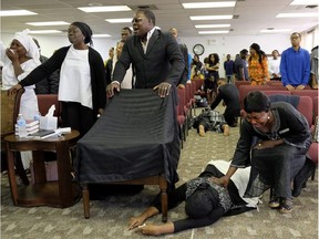 Postmedia photojournalist Larry Wong won a News Photographers Association of Canada photograph of the year award Saturday, April 28, 2018 for this picture of congregation members collapsing as they are overcome with grief during a memorial service at Solid Rock Church International in Edmonton last Sept. 24.