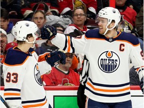 Connor McDavid celebrates his goal with Ryan Nugent-Hopkins (L) in the second period as the Ottawa Senators take on the Edmonton Oilers in NHL action at the Canadian Tire Centre in Ottawa.