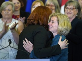 Carlynn McAneeley (left), a survivor of sexual violence, is hugged by Alberta Premier Rachel Notley (right) at the Alberta Legislature on Tuesday May 1, 2018 where the Premier proclaimed the month of May as Sexual Violence Awareness Month with a commitment to change attitudes, raise awareness and promote a culture of consent. (PHOTO BY LARRY WONG/POSTMEDIA)