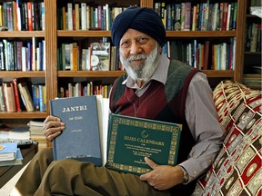 Pal Singh Purewal holds two books about calendars that he authored. The retired computer engineer set about working on a new calendar for Sikhs in the 1950s.