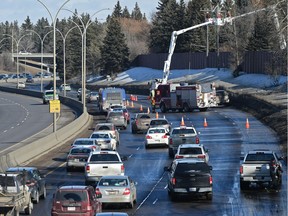 An Epcor crew on the scene with Edmonton Fire Rescue after a transformer fire ties up rush-hour traffic on Whitemud Drive near 156 Street in Edmonton on Friday, March 23, 2018.