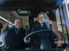 Premier Rachel Notley is behind the wheel of a transit bus with Transportation Minister Brian Mason after announcing funding for a new St. Albert transit park and ride at St. Albert Place on Monday, March 26, 2018.