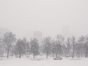 A spring snow obscures the view of downtown from Telus Field, on March 27, 2018.