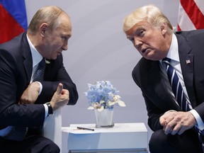 In this file photo taken on Friday, July 7, 2017, U.S. President Donald Trump, right, meets with Russian President Vladimir Putin at the G-20 Summit in Hamburg, Germany.