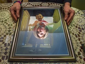 Tima Kurdi reflected in a portrait of her nephew Alan.
