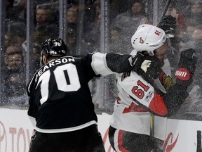 Los Angeles Kings winger Tanner Pearson checks Ottawa Senators winger Mark Stone into the glass earlier this season. (AP PHOTO)