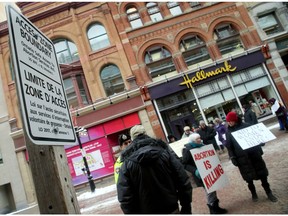Temporary signs marking the 50-metre line protesters can't cross over on Sparks Street in Ottawa after a new law established safe zones around abortion clinics. File photo.