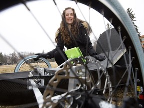 Natasha Pye, second year University of Alberta engineering physics student and assistant project manager for the Eco Car Team, poses for a photo with a new zero-emissions vehicle that engineering students designed and built, in Edmonton Thursday March 30, 2017.
