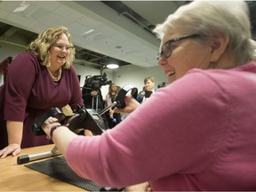 Health Minister Sarah Hoffman (left) chats with Moving for Memory program participant Mae Gerow, as she uses an arm ergometer at the Edmonton Southside Primary Care Network, 3110 Calgary Trail, in Edmonton Tuesday Dec. 19, 2017. File photo.