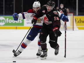 Edmonton Oil Kings forward Tomas Soustal, left, battles Moose Jaw Warriors forward Brayden Burke during WHL action at Rogers Place in Edmonton on Jan. 6, 2018.