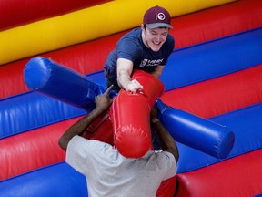 Mats Lyseng (top) and Desmond Ojong take part in a foam jousting battle during the year-end Inflatables Party at NAIT's Centre for Applied Technology, in Edmonton Wednesday April 4, 2018.