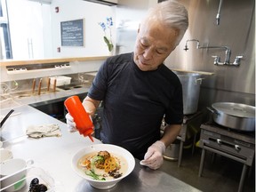 Owner Tatsuo Asai garnishes a bowl of the Goma Goma ramen at Tokiwa Ramen, 11978 104 Ave, in Edmonton Wednesday April 4, 2018.