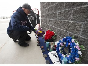 Strength and conditioning coach Dan Lajoie tends a memorial he set up outside Athletes Nation One for Stephen Wack, in St. Albert Saturday April 7, 2018. Wack trained at the gym in the off season. Wack, a 21-year-old defenceman from St. Albert was killed in the Friday Humboldt Broncos bus crash. Photo by David Bloom