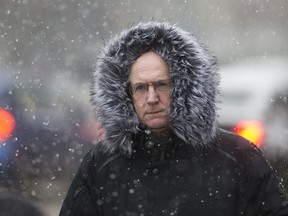 A pedestrian makes their way through the falling snow near Jasper Avenue and 101 Street, in Edmonton Monday April 16, 2018.