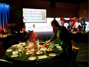 Kelsey Brown makes last minute adjustments to a table during the Children's Wish Foundation's "I Wish For a New Waiter" gala at the Shaw Conference Centre in Edmonton on Thursday, April 12, 2018.