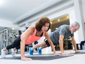 A couple do some push-ups.