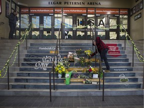 HUMBOLDT,SK--APRIL 06-9999-NEWS- Humboldt Broncos- A man drops of flowers at a memorial located inside the Elgar Petersen Arena in Humboldt, SK on Saturday, April 7, 2018.