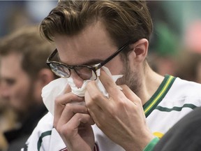 A young man wipes away tears during a vigil at the Elgar Petersen Arena, home of the Humboldt Broncos, to honour the victims of a fatal bus accident, April 8, 2018 in Humboldt.