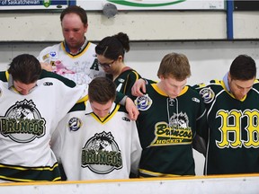 Mourners embrace each other during a moment of prayer at a vigil at the Elgar Petersen Arena, home of the Humboldt Broncos, to honour the victims of a fatal bus accident, April 8, 2018 in Humboldt, Canada. Mourners in the tiny Canadian town of Humboldt, still struggling to make sense of a devastating tragedy, prepared Sunday for a prayer vigil to honor the victims of the truck-bus crash that killed 15 of their own and shook North American ice hockey.